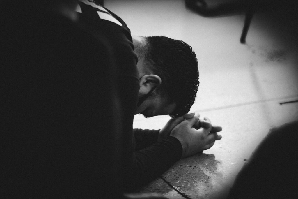 Person on their knees praying audaciously